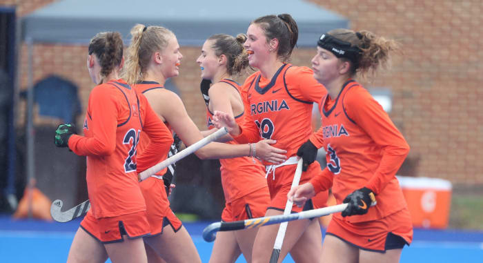 Virginia field hockey celebrates after scoring a goal.